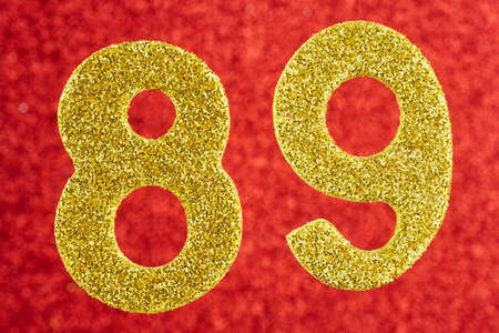 Number eighty-nine yellow color over a red background. Anniversary. Horizontalの写真素材