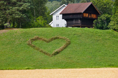 Norwegian traditional farm house and heart symbol in the countryside. Agricultureのeditorial素材