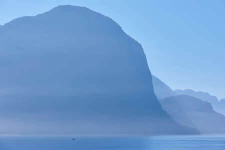 Norwegian fjord landscape sunrise in blue tone. Fisherman solitude. Horizontalの写真素材