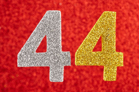 Number forty-four silver yellow color over a red background. Anniversary. Horizontalの写真素材