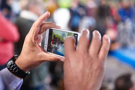 Taken photos with a smart phone. Hands detail. Horizontal