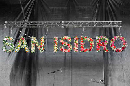 San Isidro festival signpost with flower on a stage. Horizontal