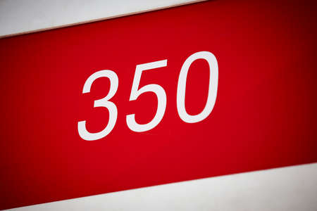 Hotel room number in red and white. Tourist apartment. Vacationの写真素材