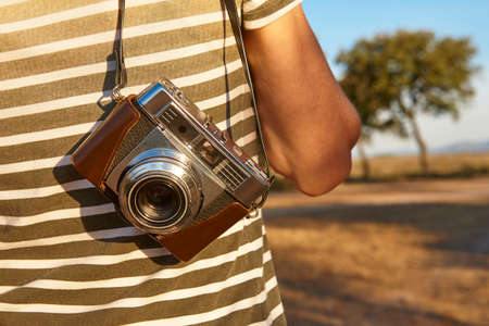 Tourist with vintage camera in the countryside. Travel background. Lifestyleの写真素材