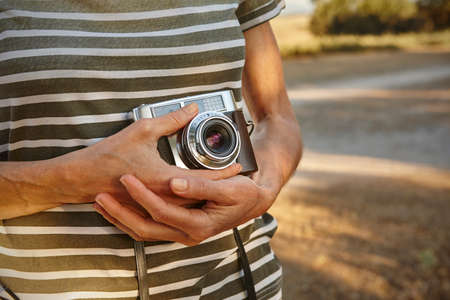 Woman taking pictures with vintage camera. Travel background.の写真素材