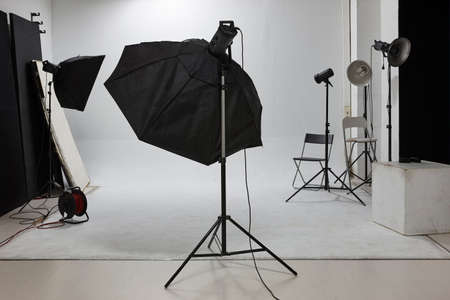 Professional photographic studio set with flashlights and white background. Equipmentの写真素材