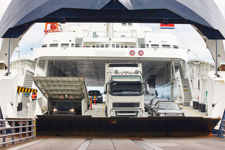 Norwegian car ferry landing at port. Open barrier. Horizontalのeditorial素材