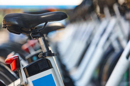 Electrical bikes on a parking. Charging batteries. Renewable energy. Horizontal