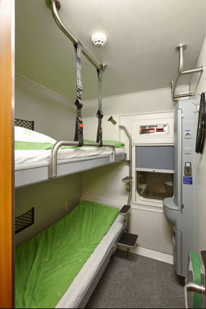Train berth indoor with two beds. Travel background. Verticalの写真素材
