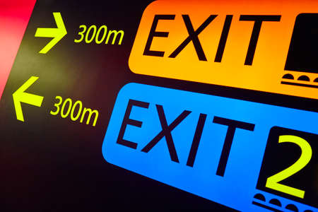Exit information signal post at airport terminal. Travel background. Horizontal