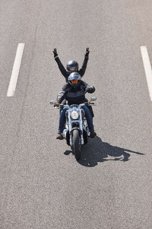 Motorcycle riders on the road. Travel and fun background. Vertical