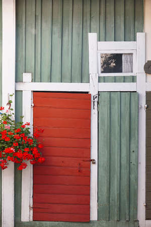 Traditional rusted finland wooden facade in green and red colorの写真素材