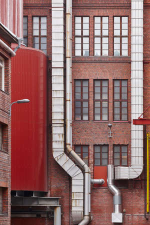 Antique red brick factory building facade in Tampere. Finland. Verticalのeditorial素材