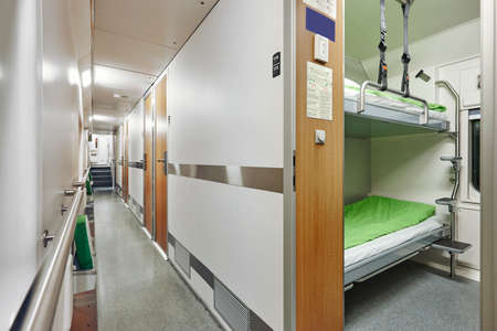 Train berth corridor indoor with two beds. Travel background. Horizontal