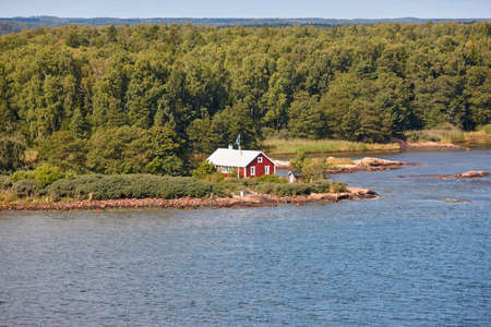 Traditional farm in the finnish forest surrounded by lake. Finlandの写真素材