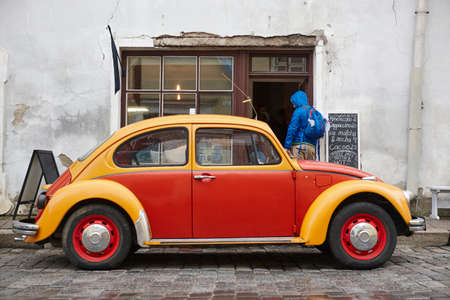 Retro classic car and grunge coffee shop facade. Travel backpacker background