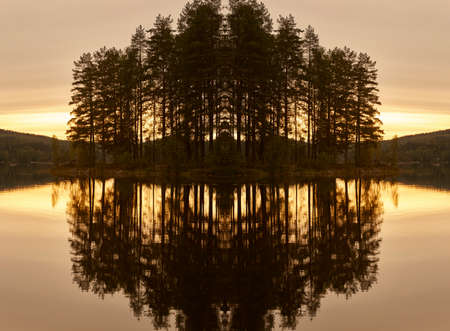 Finland landscape at sunset with lake and forest reflectionの写真素材