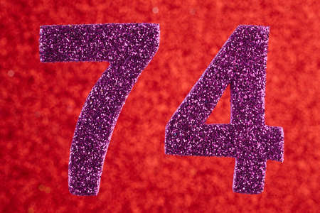 Number seventy-four purple color over a red background. Anniversary. Horizontalの写真素材