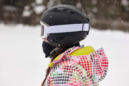 Woman with helmet on a ski slope. Winter sports. Snowingの写真素材