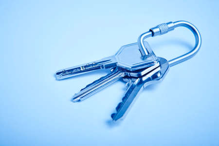 Key ring with keys on blue tone. Rent, buy. Homeの写真素材