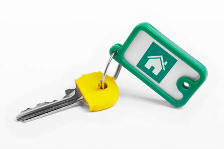 Key ring with key over white background. Rent, buyの写真素材