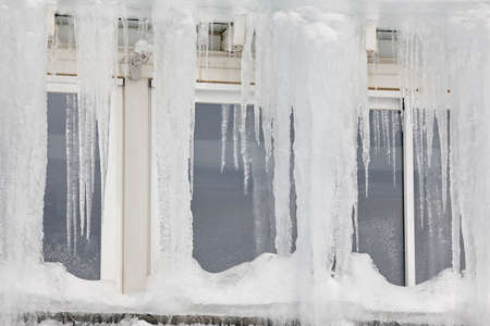 Icicle windows on winter time. Freeze temperatures backgrounds. Horizontal