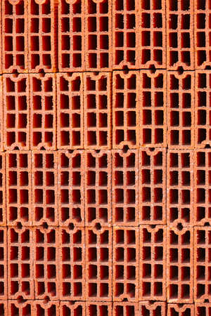 Stacked orange bricks. Construction industry. Industrial objects. Architecture. Verticalの写真素材