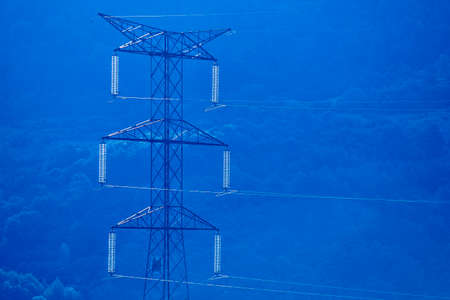 Power lines with forest background at dawn. Renewable energy. Infrastructureの写真素材