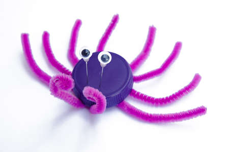 Plastic bottle cap recycled in a crab figure. Reuse garbabe. Toy