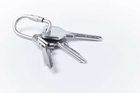 Key ring with keys over white background. Rent, buyの写真素材