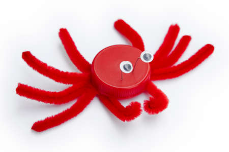 Plastic bottle cap recycled in a crab figure.