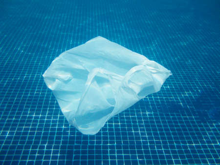 Plastic bag floating into the water.の写真素材