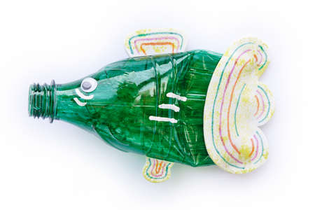 Plastic bottle recycled in a fish figure. Reuse garbage. Isolated