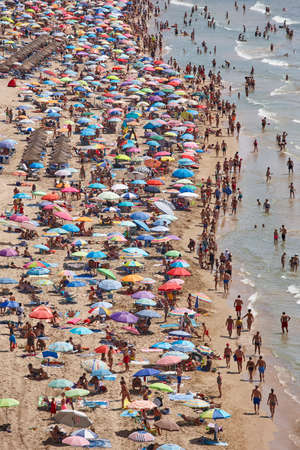 Mediterranean coastline in Spain. Calpe beach. Summer crowd. Alicante seascapeのeditorial素材
