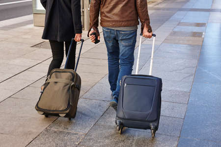 Young couple with baggage on the street. Travel and tourismの写真素材