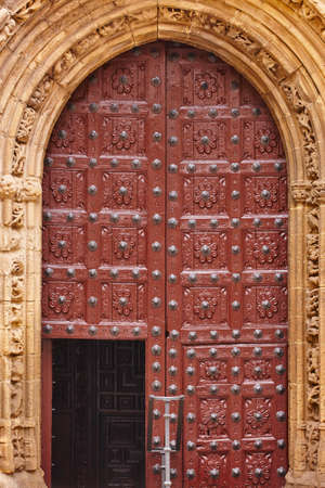 Antique wooden door and stone arch in gothic style. Spainの写真素材