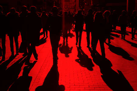People on the street. Urban crowd in red tone. Horizontalの写真素材