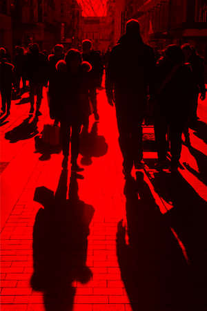 People on the street. Urban crowd in red tone. Vertical