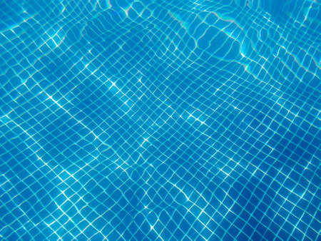 Water reflections on a swimming pool. Underwater photography. Summertime. Horizontal