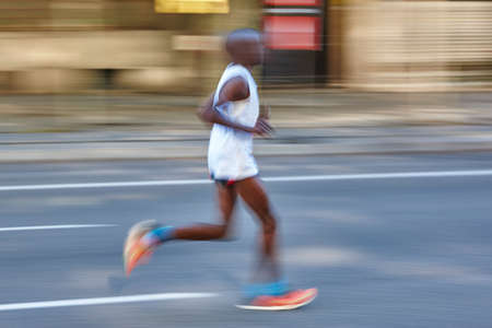Marathon runner in motion on the street. Healthy lifestyle. Exerciseの写真素材