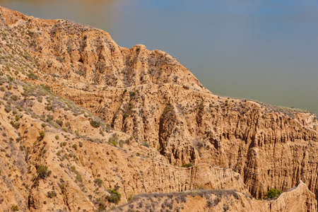 Red clay erosion gully and river. Eroded landscape. Toledo, Spainの写真素材