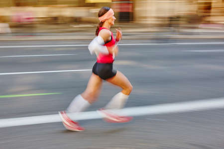 Marathon runner in motion on the street. Healthy lifestyle. Exercise