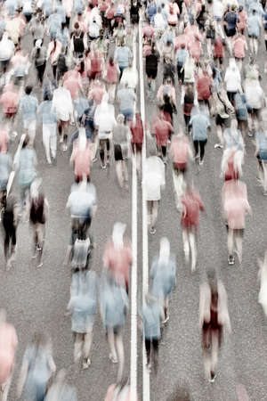 Runners on the street. Athletes in motion. Urban competition. Verticalの写真素材