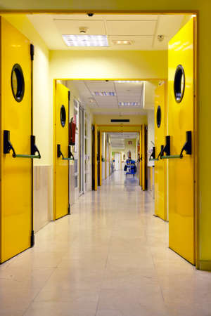 Hospital corridor indoor in yellow tone. Health center interior. Verticalの写真素材