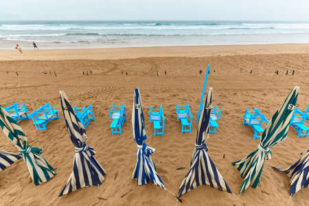 Zarautz village sand beach with umbrellas cloudy day. Euskadi, Spainの写真素材