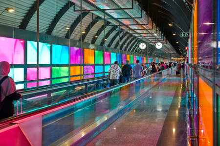 Modern airport moving walkway indoor with travelers. Transport corridor hallのeditorial素材