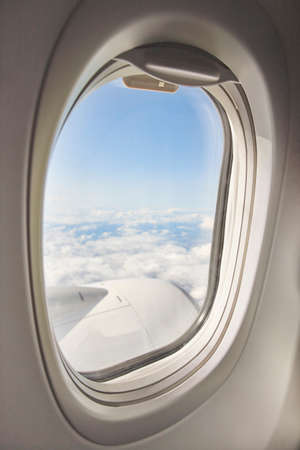 Open window with sky on a comercial aeroplane. Cabin interior. Vertical