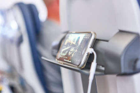 Airplane cabin interior with mobile phone charging batteries. Tourism
