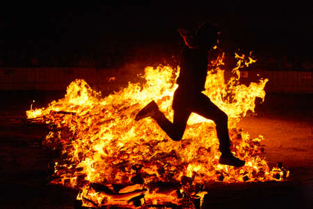 Summer solstice celebration in Spain. Jumping into the fire. Horizontalの写真素材