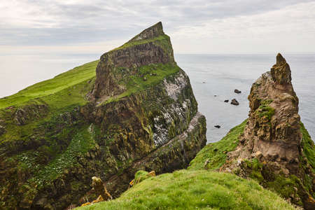 Mykines green cliffs on Faroe islands. Hiking landmark. Denmarkの写真素材